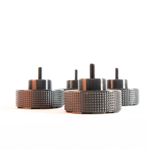 Set of four black SpinCandy isolation feet with knurled sides and threaded posts. Design may vary slightly depending on turntable model compatibility.